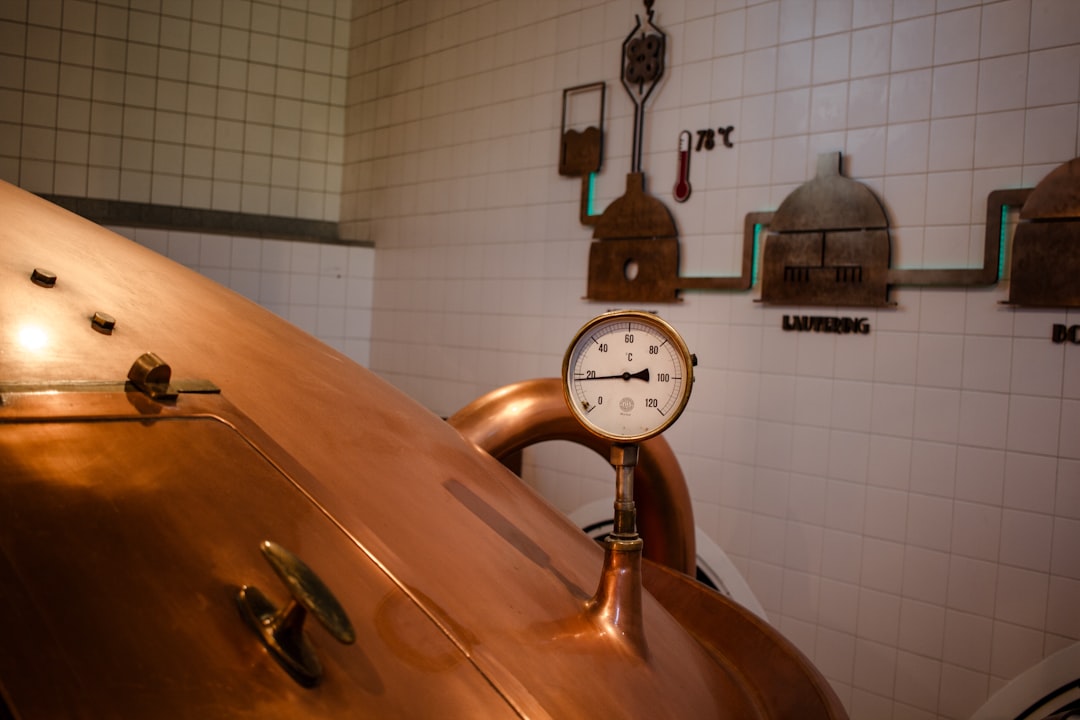 A large copper pot with a clock on top of it